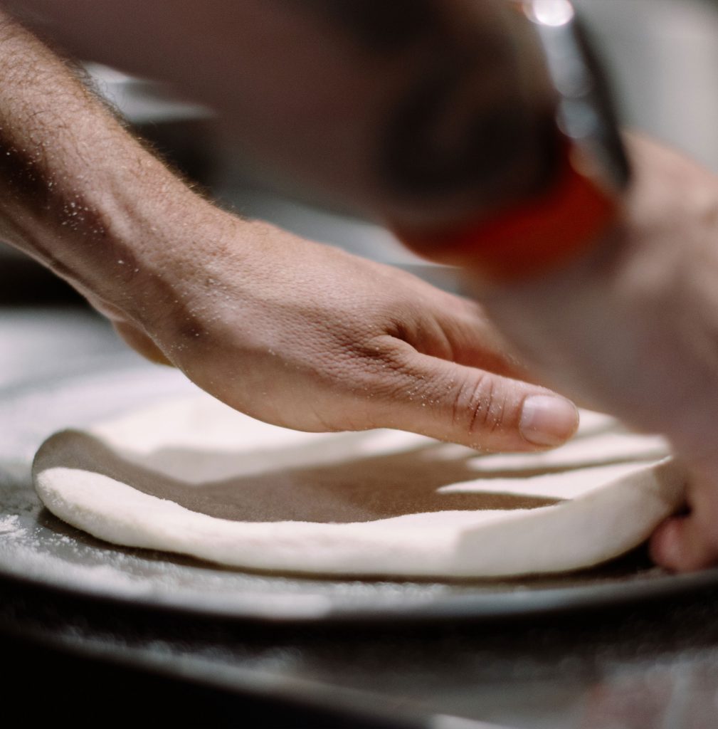 Pizza dough being prepared