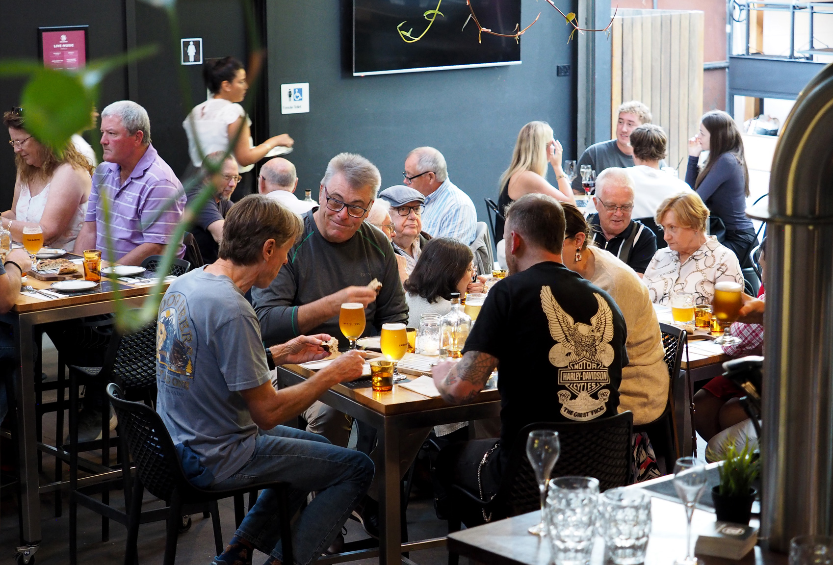 Customers eating and drinking at Tar Barrel Brewery and Distillery